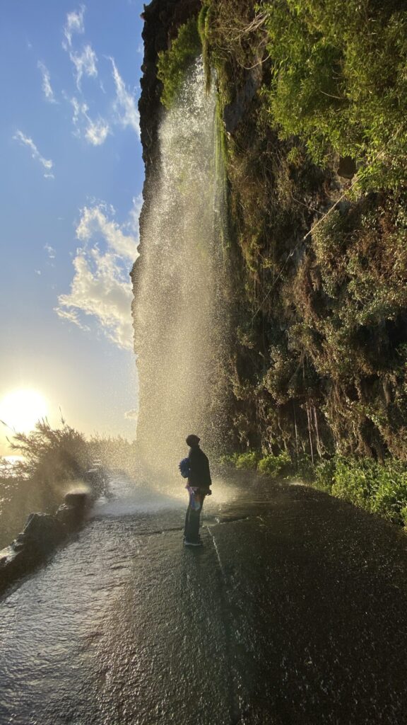 Me looking up in awe at a waterfall