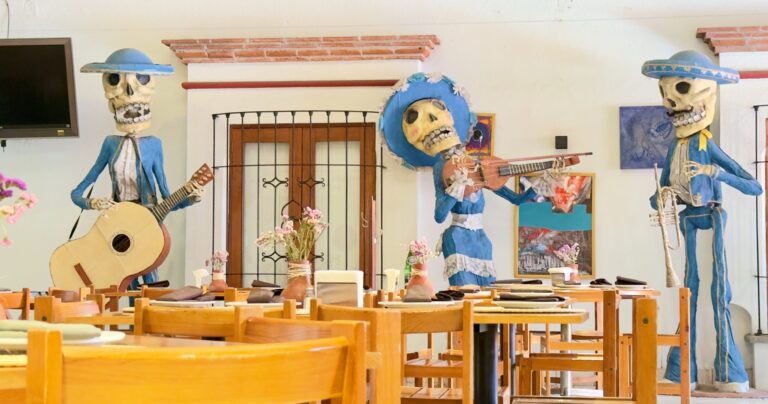Life-size skeleton mariachi statues, striking festive poses in a restaurant