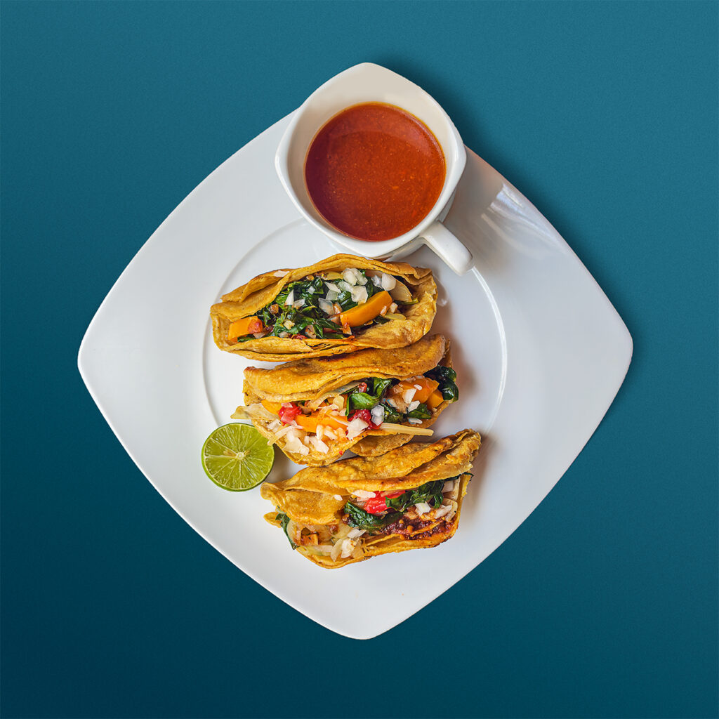 Birria tacos enhanced with sauteed vegetables